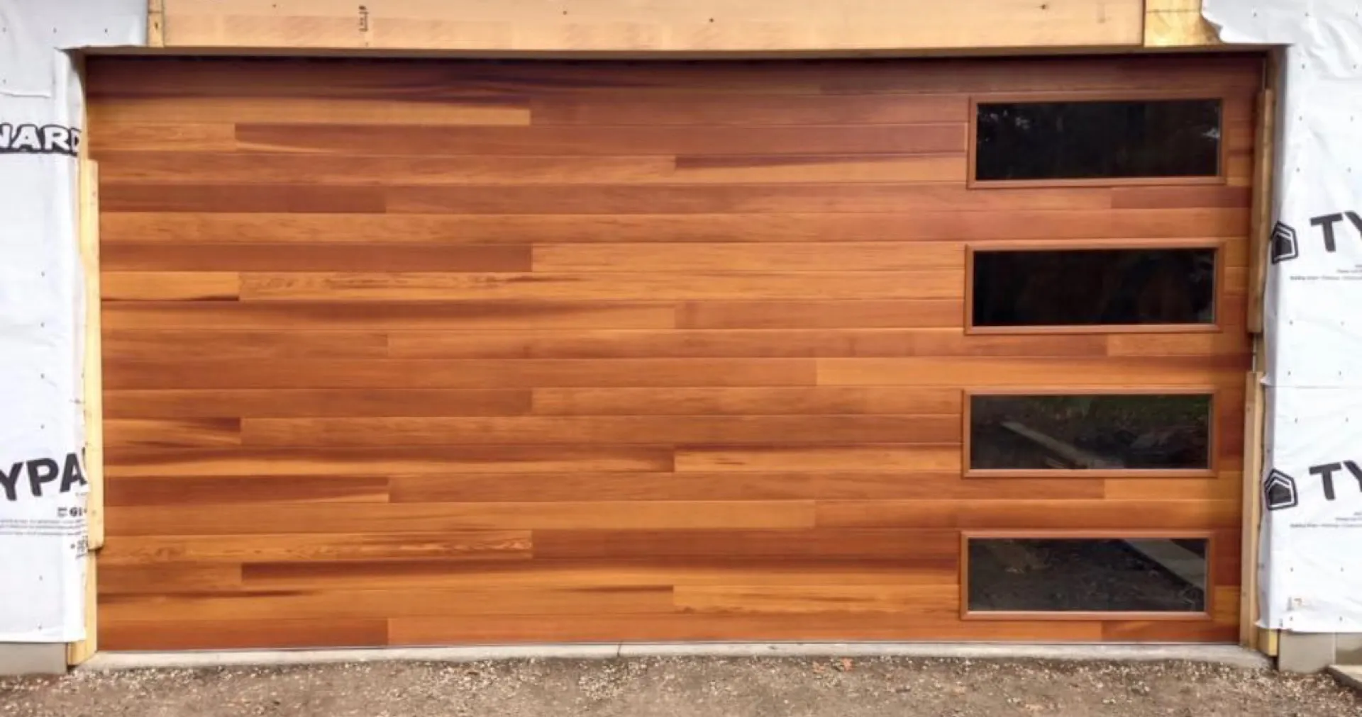 Modern cedar garage door with vertical window cutouts