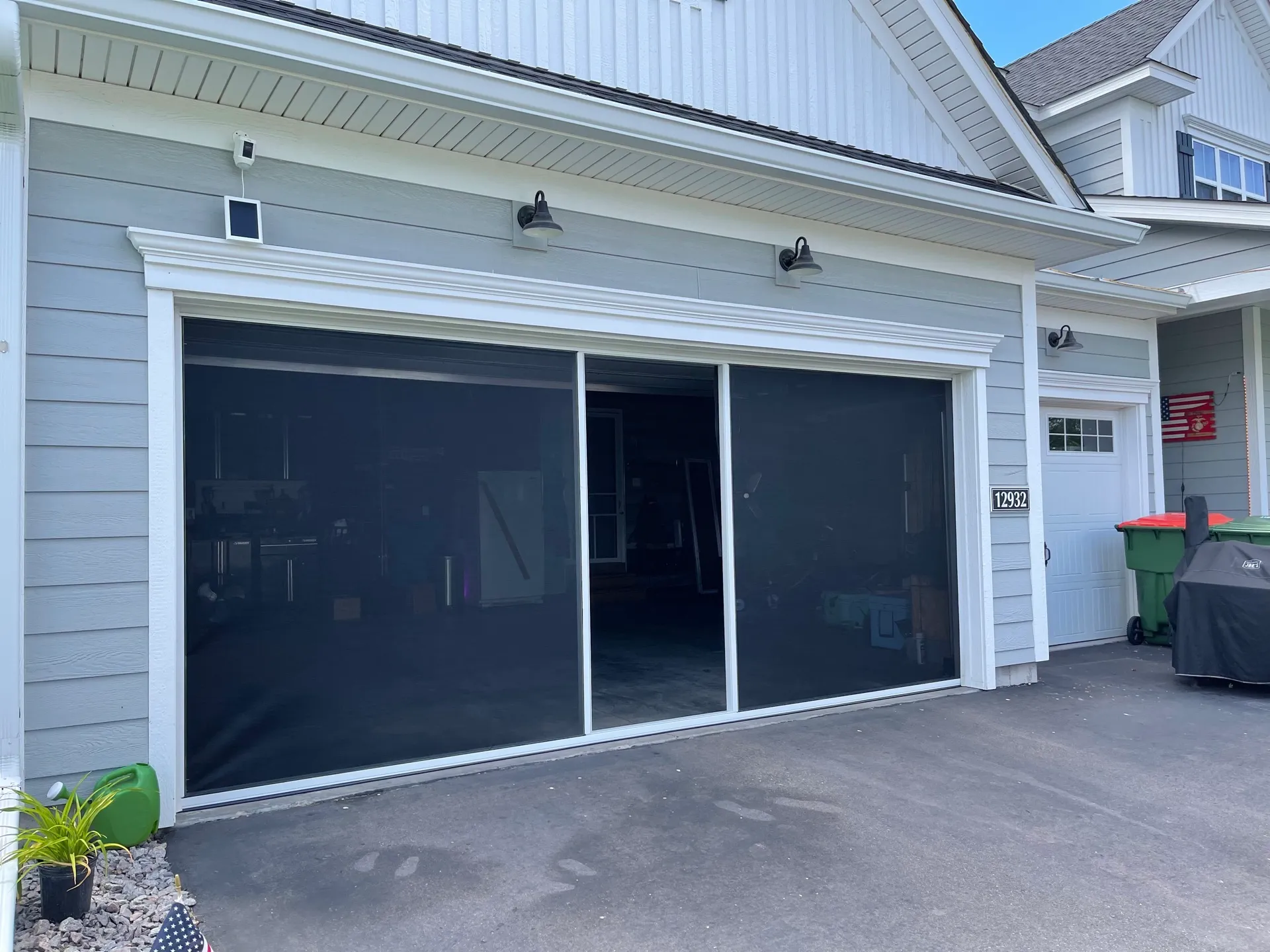 Motorized Lifestyle Screen installed across a double-car garage opening